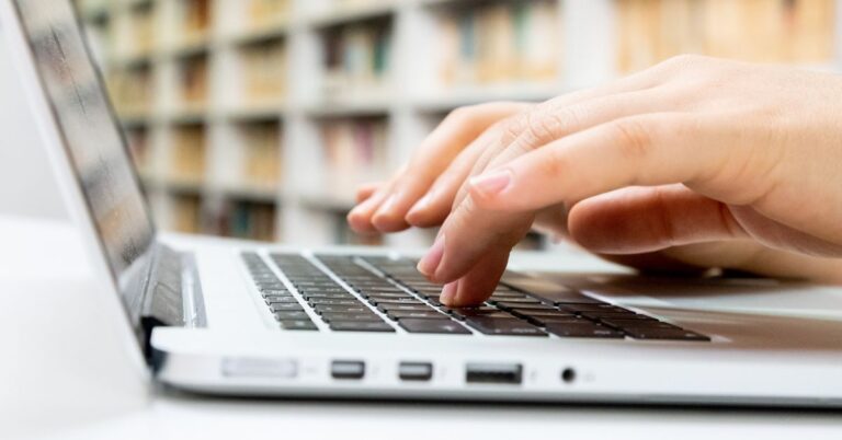 picture of someone typing using a laptop