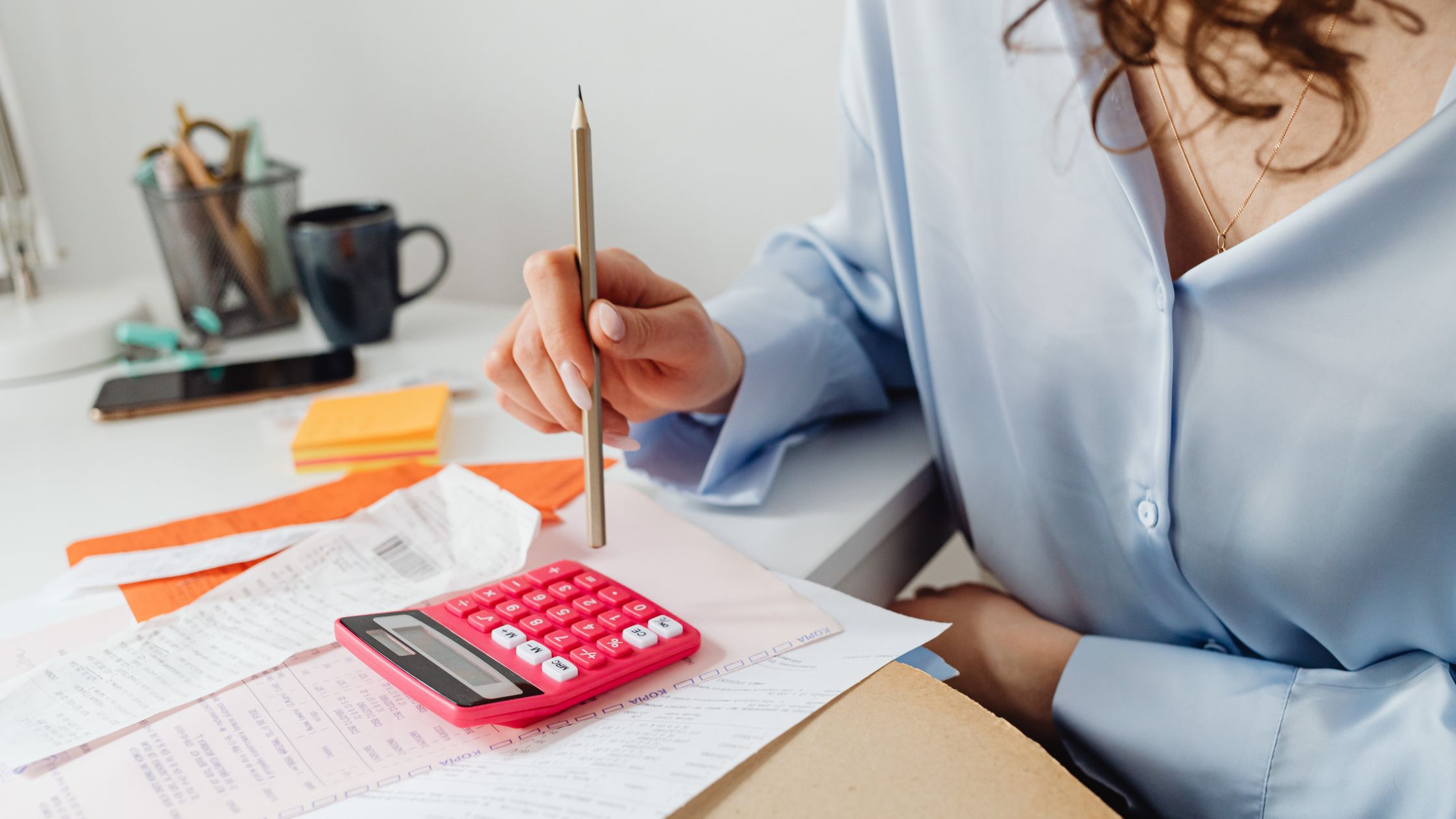 picture of someone working out expenses on a calculator