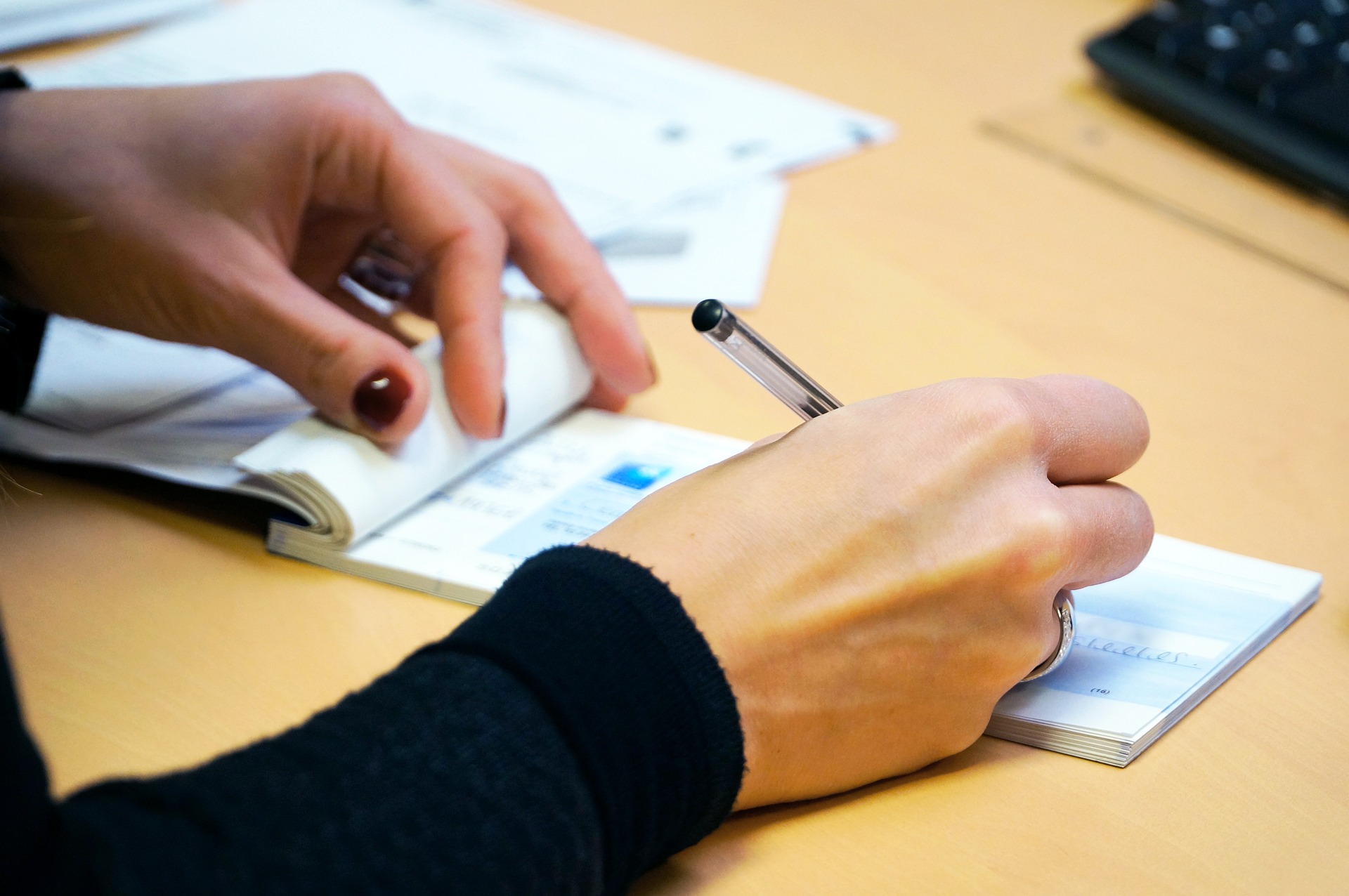 picture of someone writing a cheque