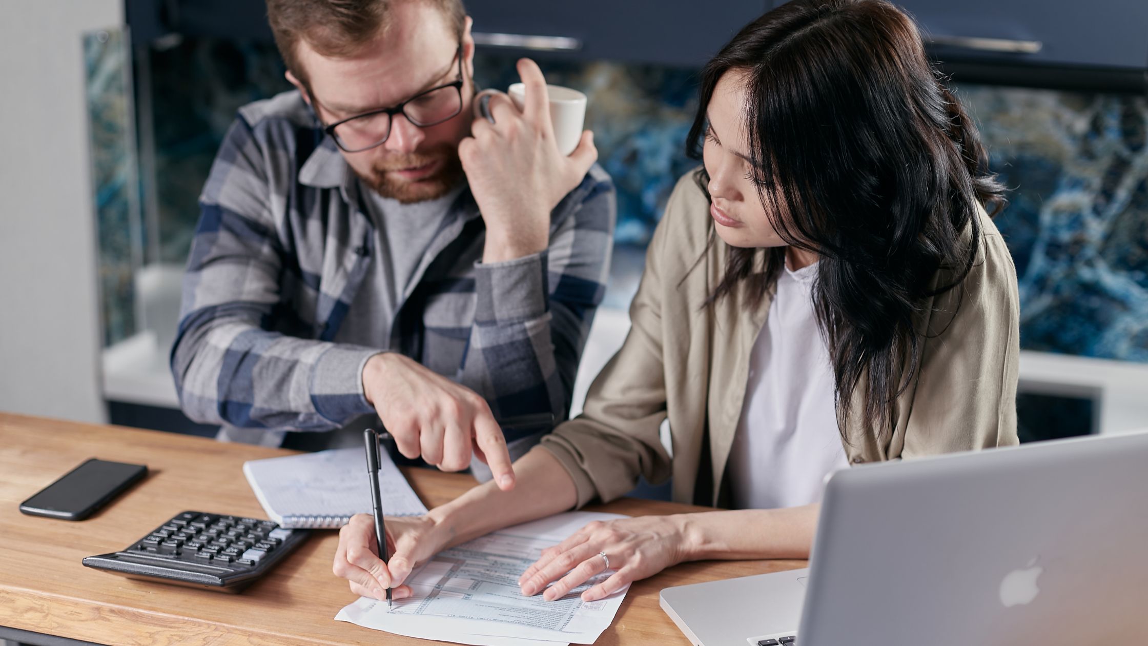 picture of couples working on their budget