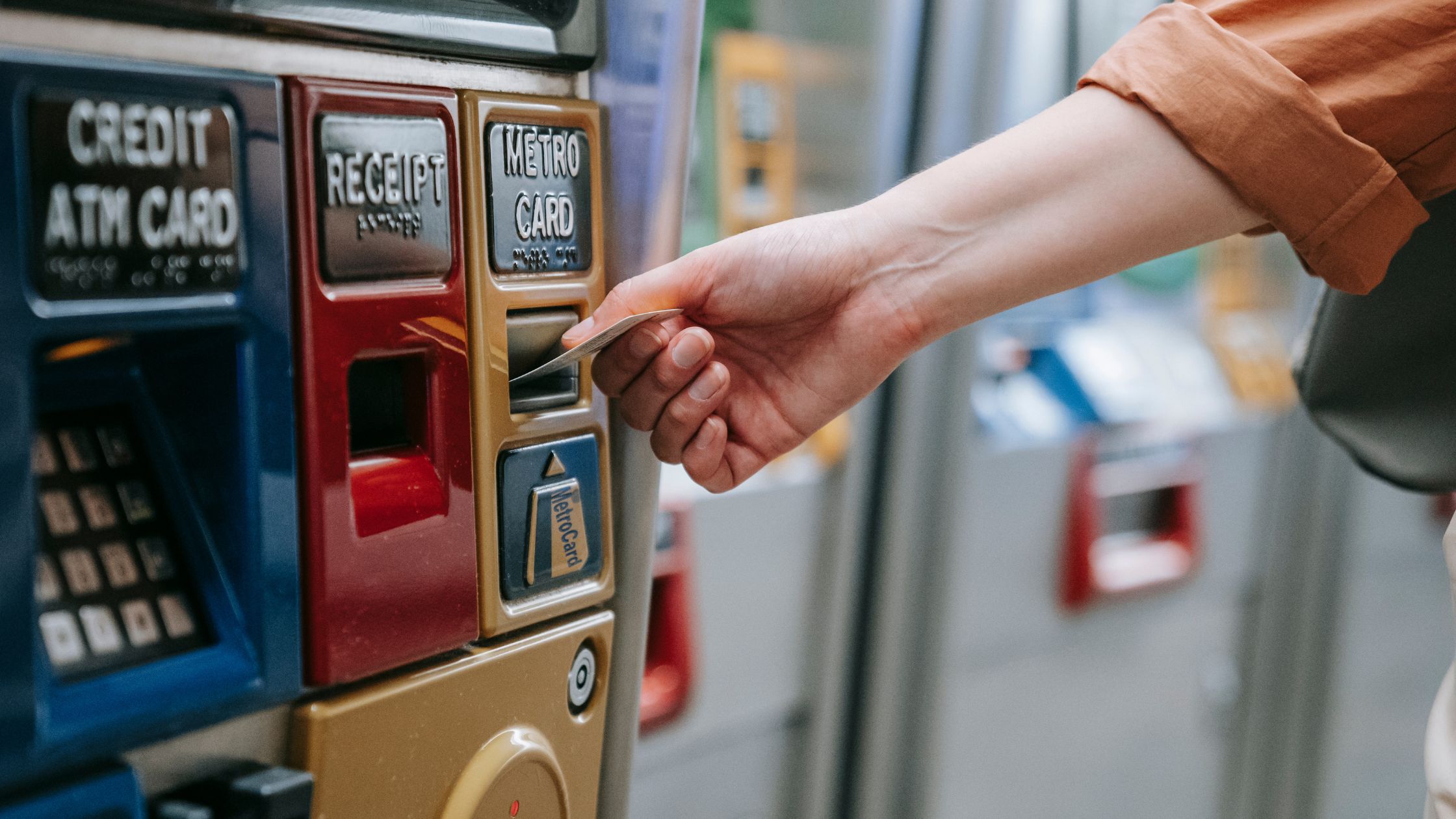 picture of a person putting an Atm in an Atm machine