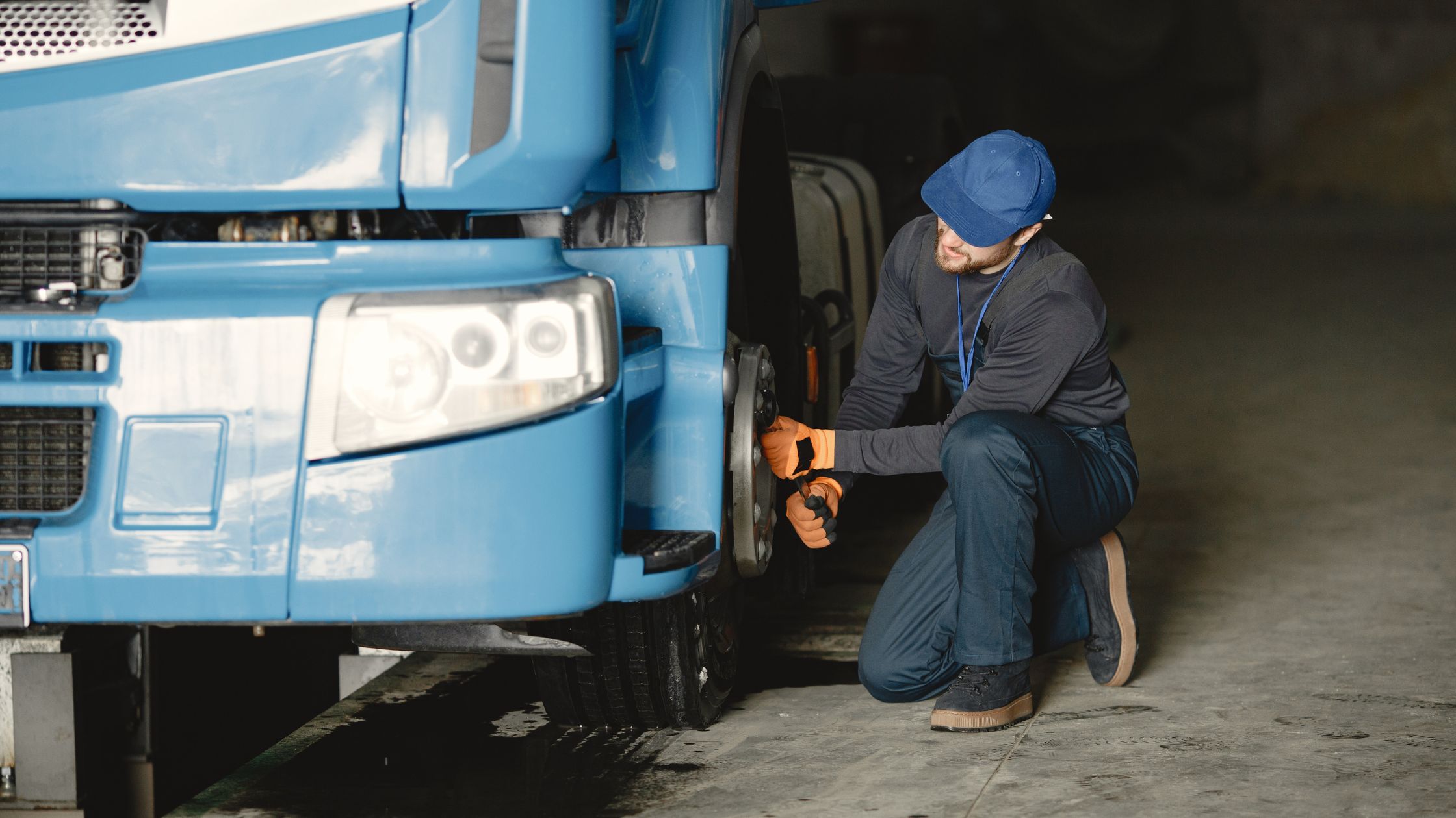 A truck driver fixing a tire