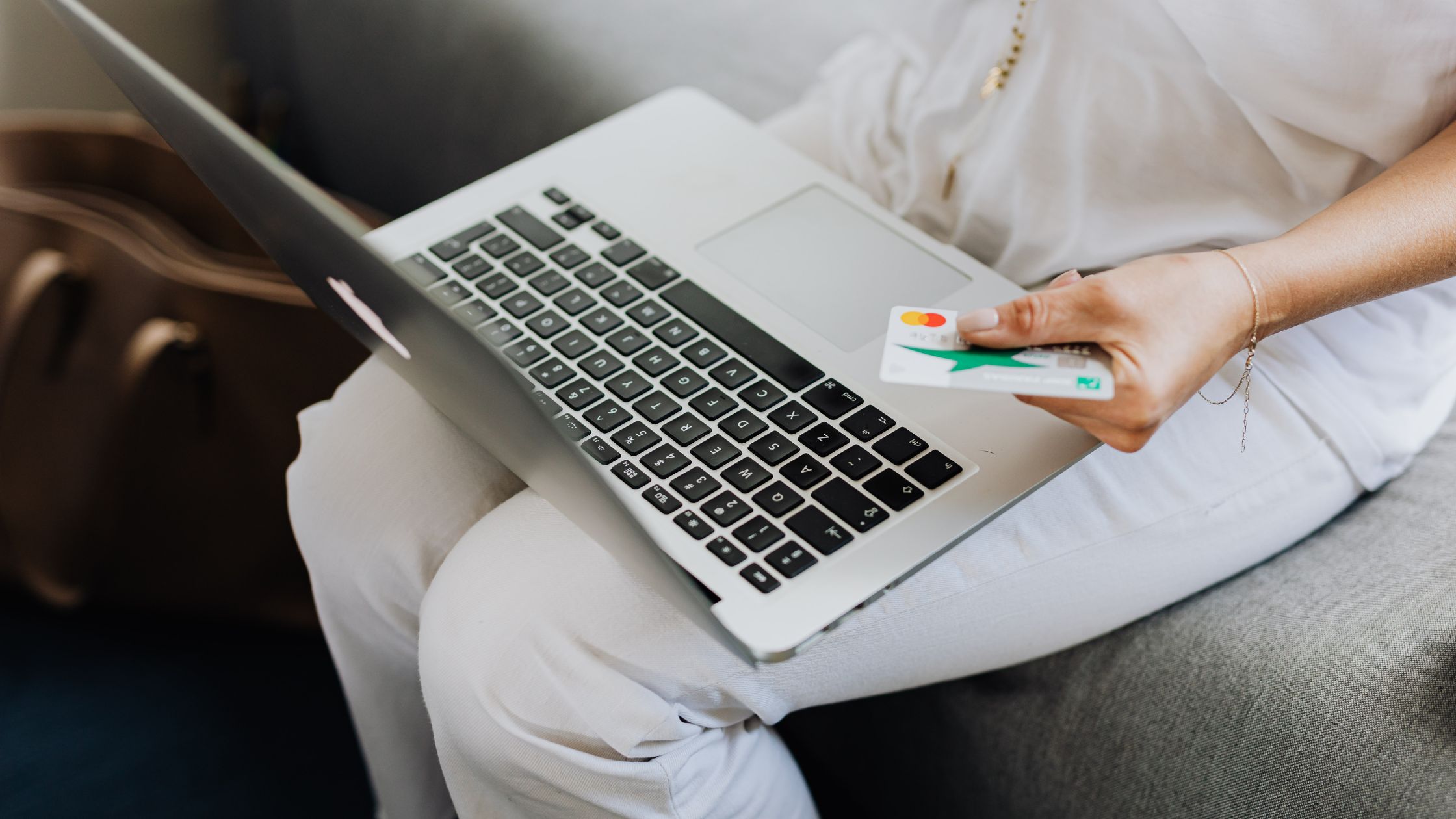 A lady using a credit card to shop online