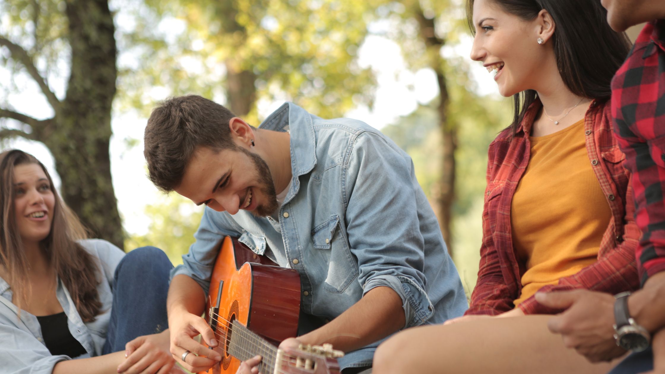 Friends having fun playing guitar