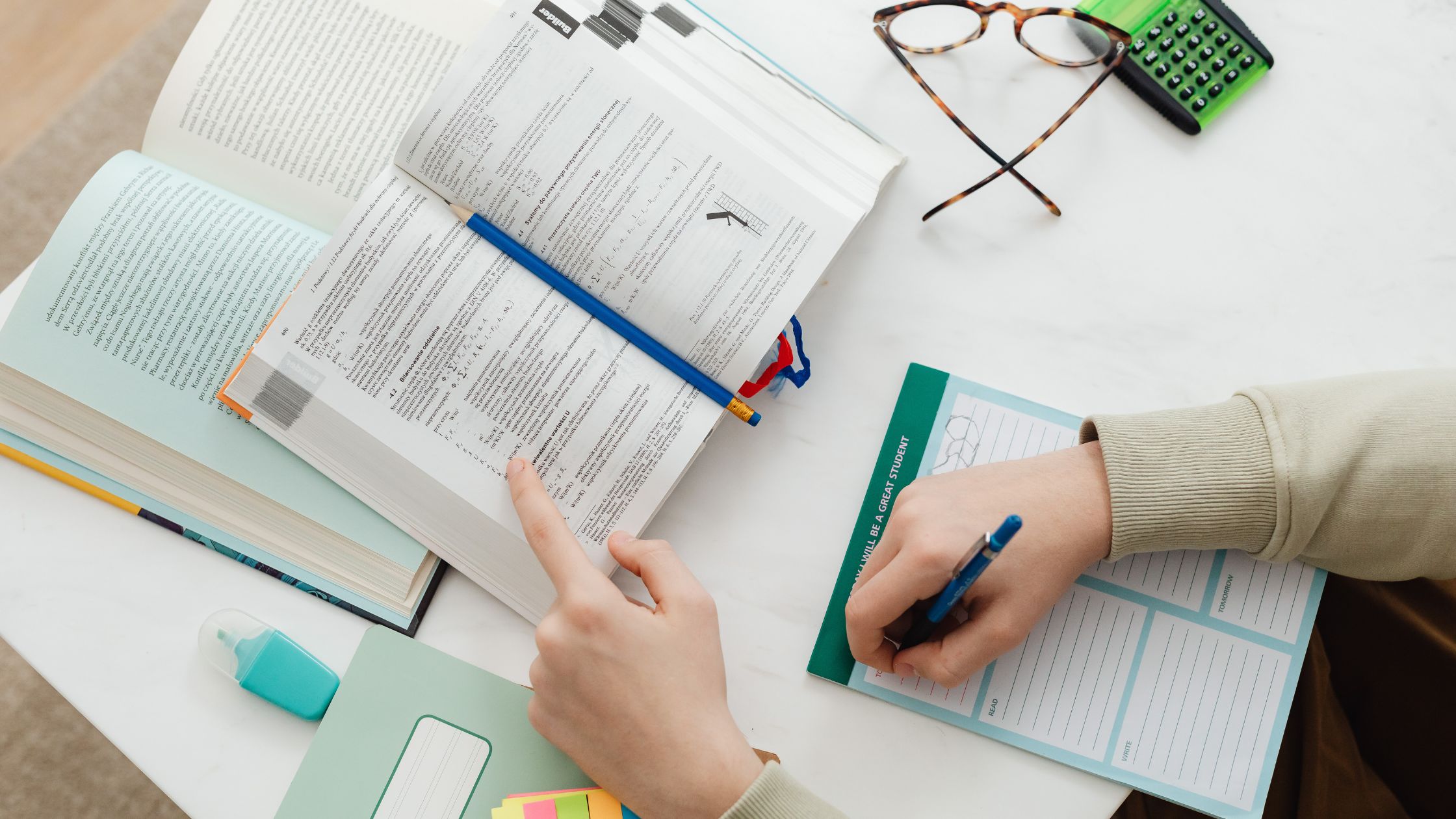 A person with books on table studying